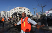 GAZA CITY : Palestinians inspect a destroyed bus after Israeli airstrikes in the central Gaza City.
