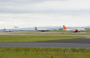 Military jet escorts passenger plane into Manchester Airport, Britain - 05 Aug 2014