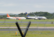 Military jet escorts passenger plane into Manchester Airport, Britain - 05 Aug 2014