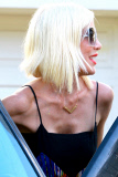 Tori Spelling and Dean McDermott pucker up at Finn Davey's birthday