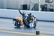 Motorcycle drag racer clings onto back of competitor's bike after high-speed crash at the Santa Pod Raceway, Bedfordshire, Britain - 10 Sep 2014