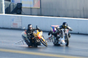 Motorcycle drag racer clings onto back of competitor's bike after high-speed crash at the Santa Pod Raceway, Bedfordshire, Britain - 10 Sep 2014