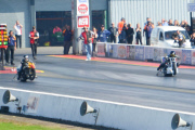 Motorcycle drag racer clings onto back of competitor's bike after high-speed crash at the Santa Pod Raceway, Bedfordshire, Britain - 10 Sep 2014