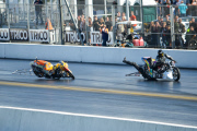 Motorcycle drag racer clings onto back of competitor's bike after high-speed crash at the Santa Pod Raceway, Bedfordshire, Britain - 10 Sep 2014