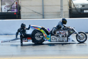 Motorcycle drag racer clings onto back of competitor's bike after high-speed crash at the Santa Pod Raceway, Bedfordshire, Britain - 10 Sep 2014