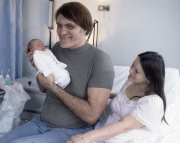 American actor Richard Kiel ( 'Jaws" ) holds his baby daughter Jennifer for the first time in hospital with wife Diane by his side. 1978.