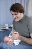 American actor Richard Kiel ( 'Jaws" ) holds his baby daughter Jennifer for the first time in hospital with wife Diane by his side. 1978.