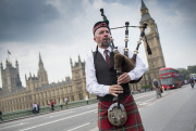 A Scottish Piper plays in front of the Houses of Parliament in Westminster, London, Britain - 18 Sep 2014