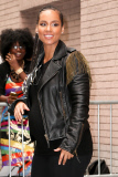 Alicia Keys shows off a rocker look with a black leather jacket and a baby bump