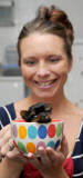 Woman hand raises tiny miniature Yorkshire Terrier dog, Great Yarmouth, Norfolk, Britain - 12 Oct 2014