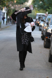 A Makeup Free Liv Tyler Hides Face from Photographers Carrying a Hatchet and Skeleton Costume