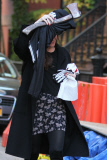 A Makeup Free Liv Tyler Hides Face from Photographers Carrying a Hatchet and Skeleton Costume