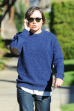 A serious Ellen Page chats on the phone as she heads to a friend's house