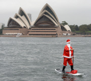 Father Christmas paddle boarding in Sydney Harbour, Australia - 18 Dec 2014