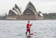Father Christmas paddle boarding in Sydney Harbour, Australia - 18 Dec 2014
