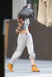 Kendall Jenner shows off her rock-hard abs while struggling to hide her face