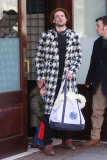 Tom Sturridge waves to photographers as he exits his hotel in Tribeca