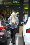 Miley Cyrus plays peek-a-boo with photographers as she leaves Earth Bar