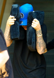 Justin Bieber takes cover exiting the studio