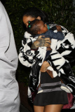 Rihanna cradles a baby after dinner at G Baldi