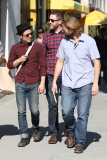 Hipster Elijah Wood chats with friends after lunch