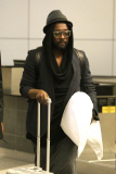 Will.i.am tries to go incognito upon arrival at LAX
