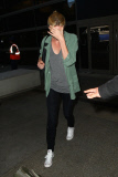 A shy Charlize Theron returns from her Paris movie premiere