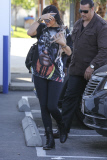 Kylie Jenner cuddles her new pup as she arrives at the studio