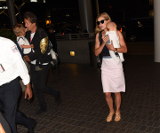 Rosamund Pike all smiles carrying baby Atom through LAX **NO UK**
