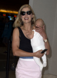Rosamund Pike all smiles carrying baby Atom through LAX **NO UK**
