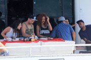 Wild-haired Rihanna hitches a ride on a deep sea fishing boat