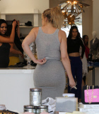Khloe Kardashian films at DASH is tight grey skirt