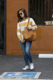 Minka Kelly hides behind her handbag for a FedEx run
