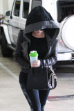 A shy Khloe Kardashian covers up as she hits the gym