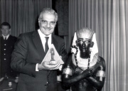 Egyptian Actor Omar Sharif Holding A 1460bc Jar Who Is To Host The Programme. A Model Of Tutankhamun Sets The Tone For Today's Announcement At London's Dorchester Hotel Of The First Ever Live Broadcast Direct From The Gloomy Tunnels Under Egypt's