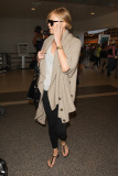 Charlize Theron keeps her head low as arrives at LAX to catch her flight