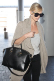 Charlize Theron keeps her head low as arrives at LAX to catch her flight