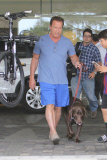 Arnold Schwarzenegger leaves his girlfriend's pad with his beloved pooch