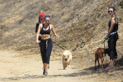 *EXCLUSIVE* Miley Cyrus multitasks on a hike in the hills with friends
