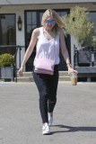 Dakota Fanning battles a strong breeze after a four hour visit to the salon