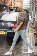 Taylor Swift wears bright white Keds on a rainy New York day