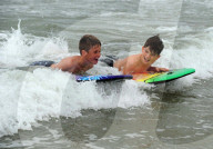 FEATURE - Surfers am  Polzeath Strand in Cornwall