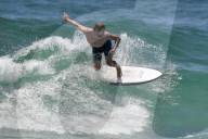 PEOPLE - Simon Baker surft sich durch die Wellen am Bondi Beach