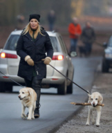 LINDA DE MOL and partner take a walk with their dogs