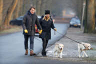 LINDA DE MOL and partner take a walk with their dogs