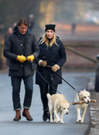 LINDA DE MOL and partner take a walk with their dogs