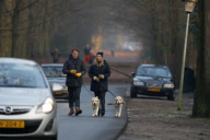 LINDA DE MOL and partner take a walk with their dogs