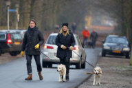 LINDA DE MOL and partner take a walk with their dogs
