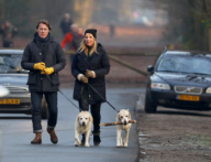 LINDA DE MOL and partner take a walk with their dogs