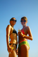 Two sexy women enjoying drinks on the beach, Ibiza 2006